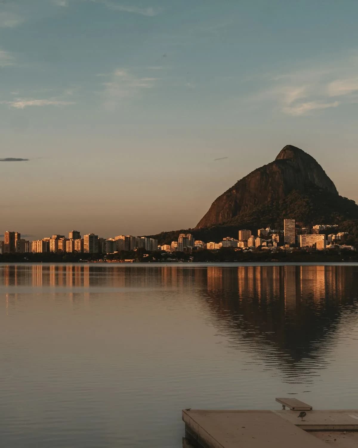 Rio de Janeiro's skyline and mountains reflected in the lagoon at sunset
